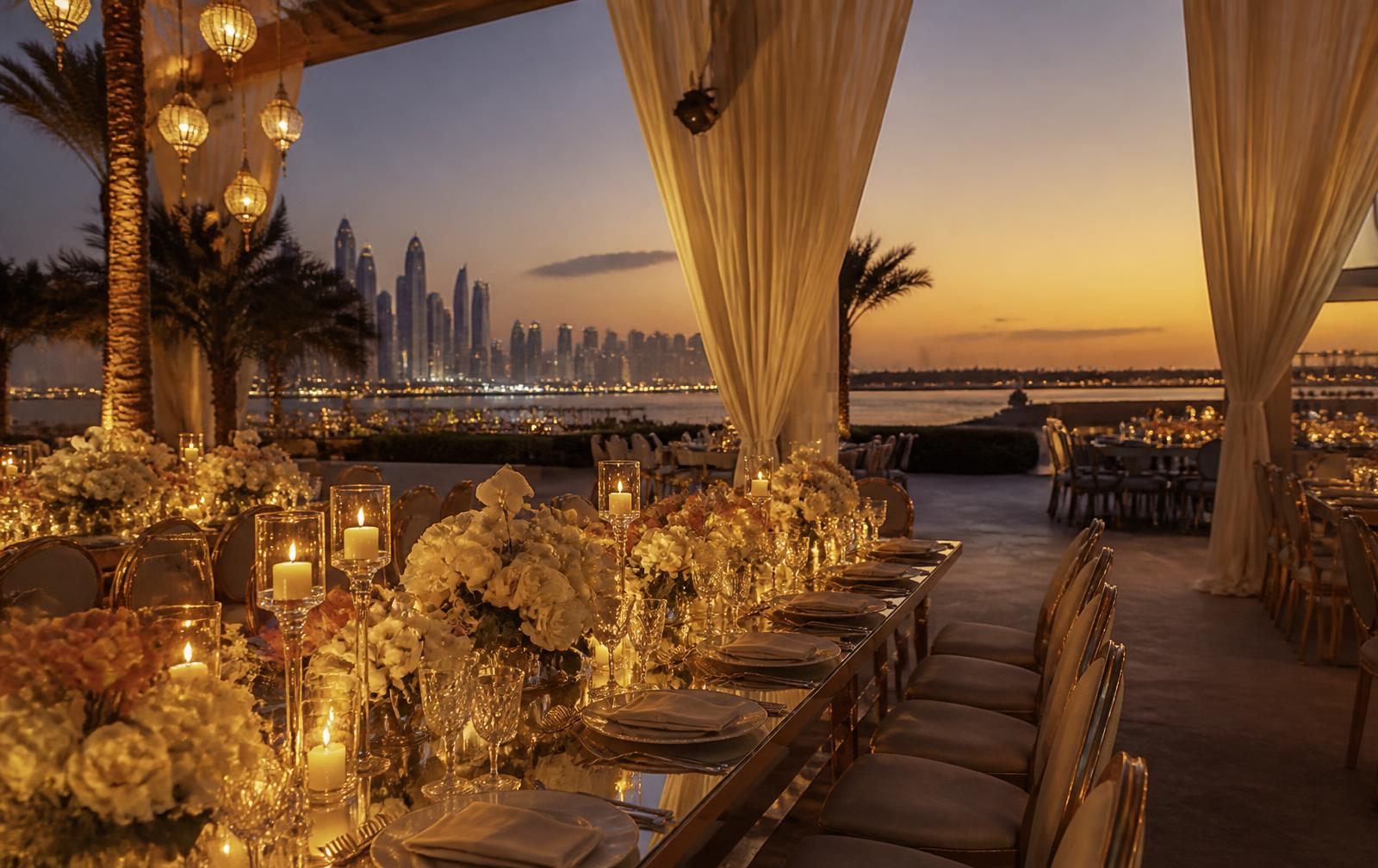 Elegant candlelit event setup arranged by Nexo Events.ae with the Dubai skyline at sunset